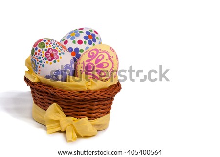 Easter eggs in basket with yellow paper ribbon and bow. The eggs are hand painted. Unique. Wicker basket. Isolated white background. The horizontal location of the pictures.
