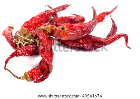 Dry hot red chili peppers on white backgrounds, low depth of field, focus on the first pepper
