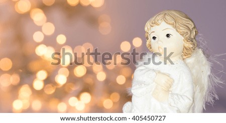 angel in-front of sparkling blurry lights background