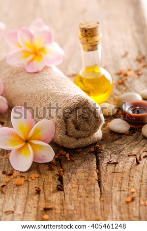 frangipani and stones ,dry flower petals ,towel on old wood

