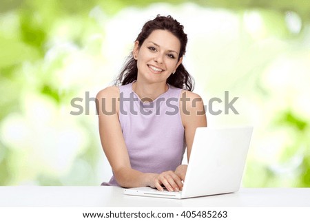beautiful happy young brunette girl smile with laptop with green background