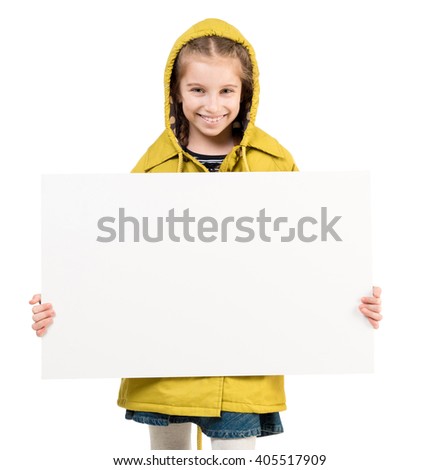 smiling little girl in coat with blank sheet in hands isolated on white background