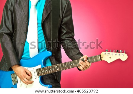 funny guitar player in concert isolated on pink
