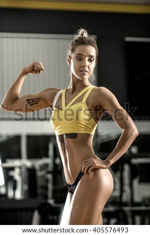 young fitness woman in gym, vertical photo