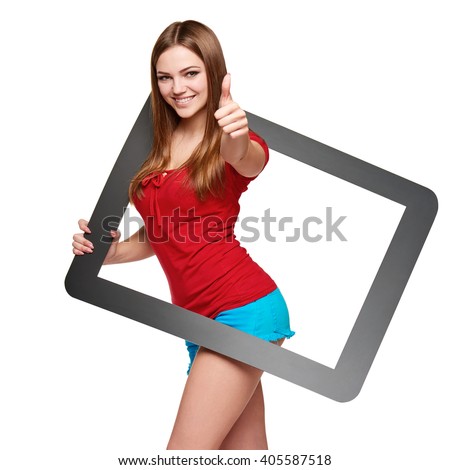 Beautiful bright girl standing looking through the frame and gesturing thumb up, over white background