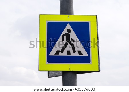 Zebra crossing, pedestrian cross warning traffic sign with bright yellow frame in Moscow, Russia