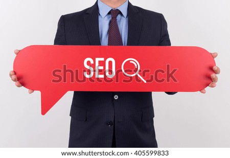 Businessman holding speech bubble with a word SEO