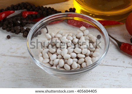 Dry soybeans in the bowl on wood background