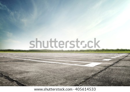 blue sky sun light and old worn runway  Royalty-Free Stock Photo #405614533