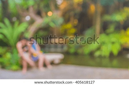 Abstract blur image of couple  and waterfall in forest for background usage.