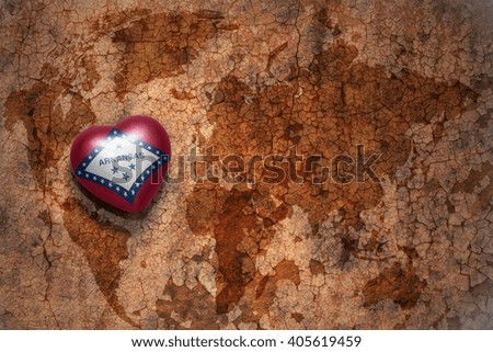 heart with arkansas state flag  on a vintage world map crack paper background. concept