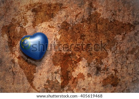 heart with nevada state flag  on a vintage world map crack paper background. concept