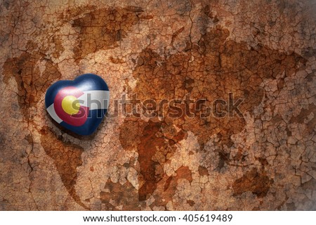 heart with colorado state flag  on a vintage world map crack paper background. concept