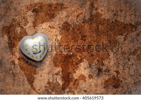 heart with rhode island state flag  on a vintage world map crack paper background. concept
