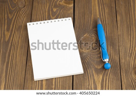 notebook and pen on the wooden table