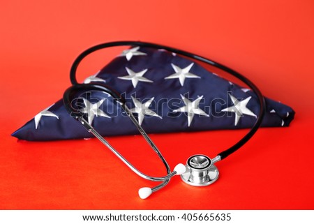 Stethoscope with stars of USA flag on red background. American medicine concept
