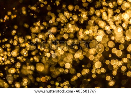 Gold bokeh of water and lights on black background