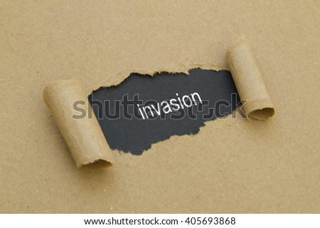 Invasion word written under torn paper.