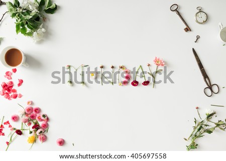 Word "MONDAY" made of flowers with various things on desk. Spring concept. Flat lay Royalty-Free Stock Photo #405697558
