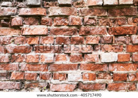   photographed close-up of an old crumbling brick wall of the building, disfocus