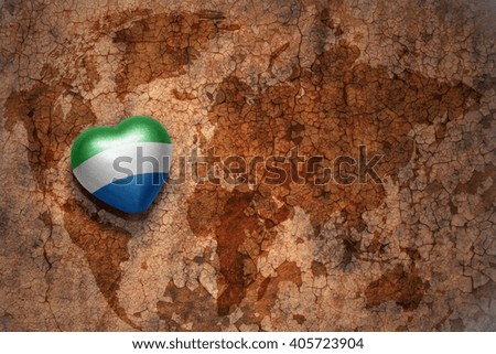 heart with national flag of sierra leone on a vintage world map crack paper background. concept