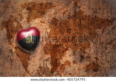 heart with national flag of angola on a vintage world map crack paper background. concept