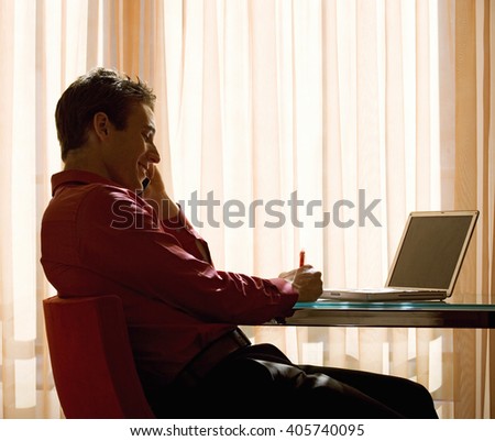 A man using a laptop at a desk