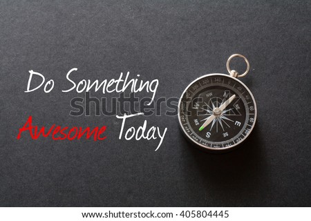 Inspirational quote : Do something awesome today ,on black background with compass