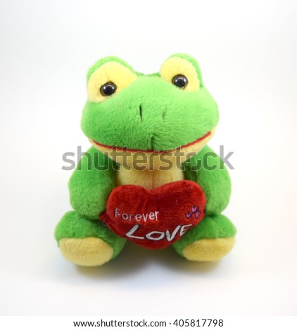 Cute stuffed yellow and green frog toy with heart, isolated