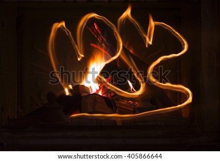 Texture of a blazing fire in the fireplace. Stone fireplace in a country house with fire, light painting. 