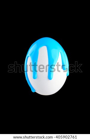 White egg drenched colors on a black background