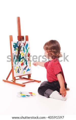 Child painting on easel with paintbrush