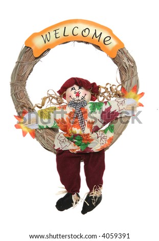 A colorful Thanksgiving wreath with scarecrow isolated over white
