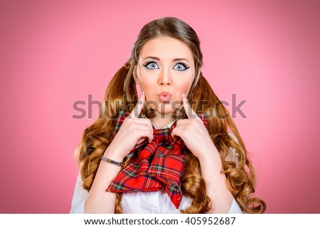 Portrait of a pretty smiling teen girl in school uniform posing over pink background. Anime style. 