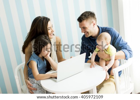 Family with the laptop at the table