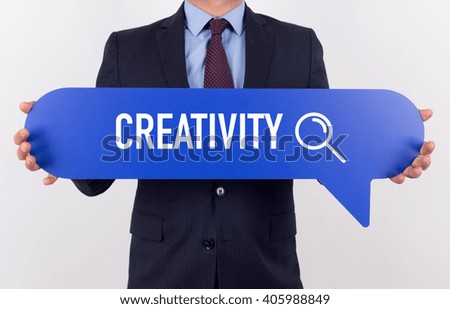 Businessman holding speech bubble with a word CREATIVITY