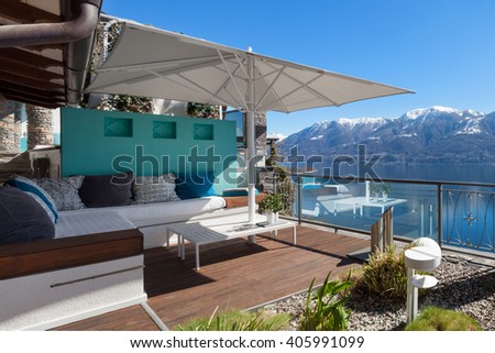 Terrace lounge with lake view in a luxury house