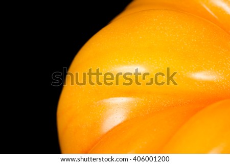 Attractive yellow tomato on a black background