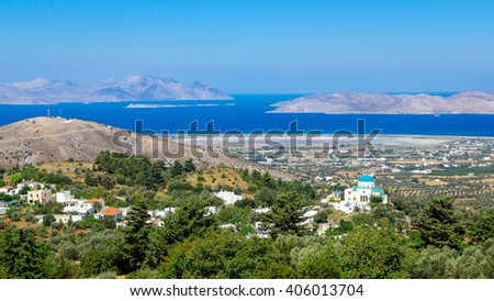Panorama of Kos island from above with a church and a lake on background
