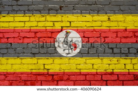 Flag of Uganda painted on brick wall, background texture