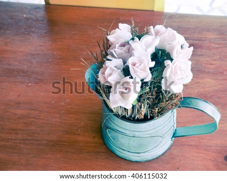 Beautiful spring flowers in vase on wooden table.Vintage Instagram style toned picture