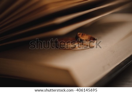 Two wedding rings on a book close up 