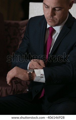 business man with an expensive watch in the interior