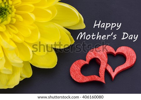 two red hearts, a chrysanthemum and a text for the Mother's Day on a blackboard