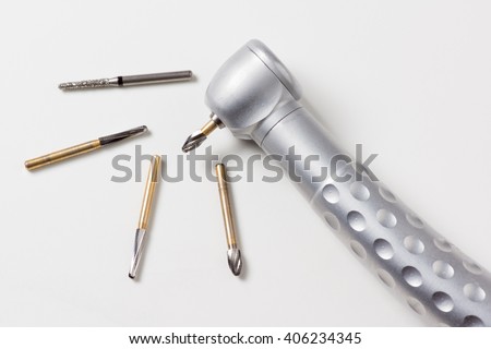 dental turbine handpiece with burs on a white background Royalty-Free Stock Photo #406234345