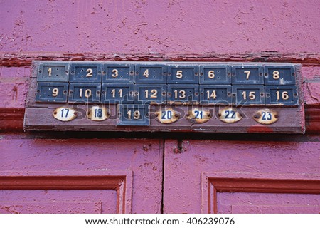 Plates with numbers of apartments above the door in an old house entrance. St. Petersburg