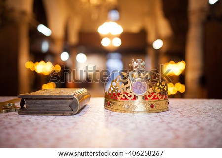 Cross, books and crowns on a wooden table Royalty-Free Stock Photo #406258267