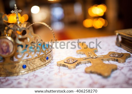 Cross, books and crowns on a wooden table Royalty-Free Stock Photo #406258270