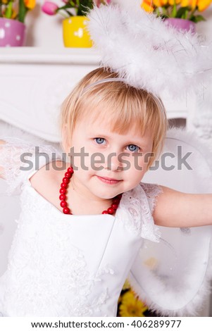 photo of Portrait of beautiful princess girl in white dress with white nimbus and wings