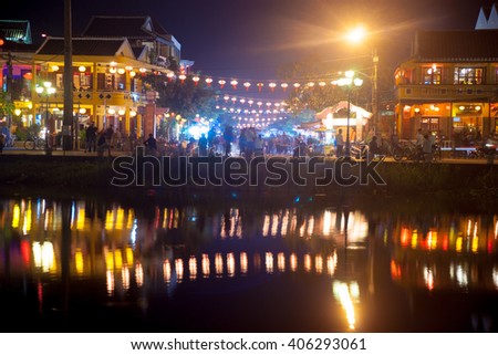 Night view of Hoi An town with light illumination and reflection in the river, Vietnam. Hoi An is the World's Cultural heritage site, famous for mixed cultures and architecture.